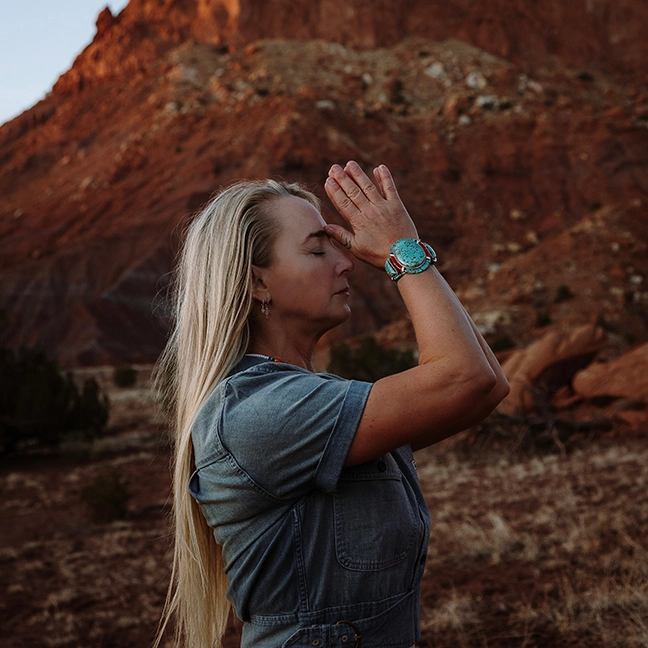 Sunset landscape in a desert with Jennifer Zona walking among beautiful rocks